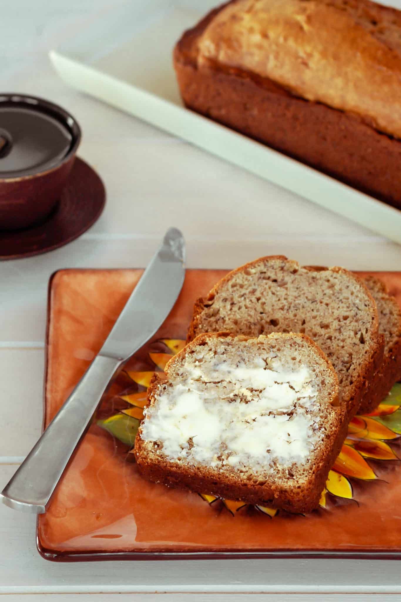 Delicious slices of banana bread topped with butter.
