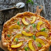 A medium size peach pizza, hot out of the oven