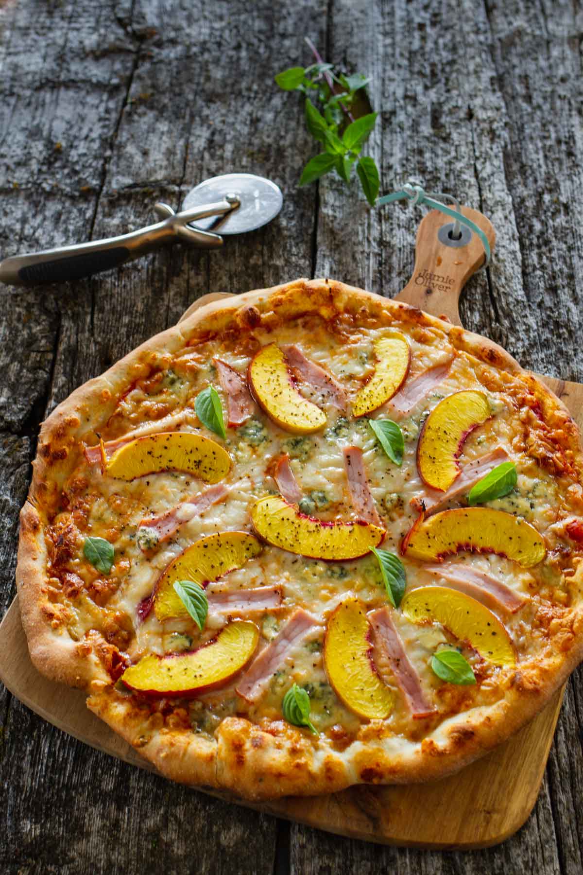 A medium size peach pizza, hot out of the oven